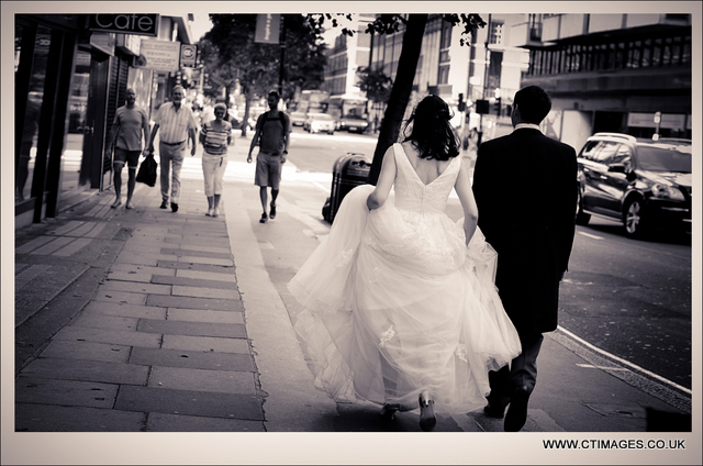 _REF7716 manchester-wedding-photography-couple-walking-through-streets