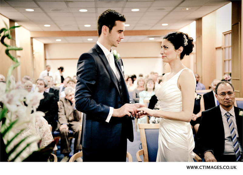 the-bride-and-groom-exchange-rings-at-manchester-wedding.jpg