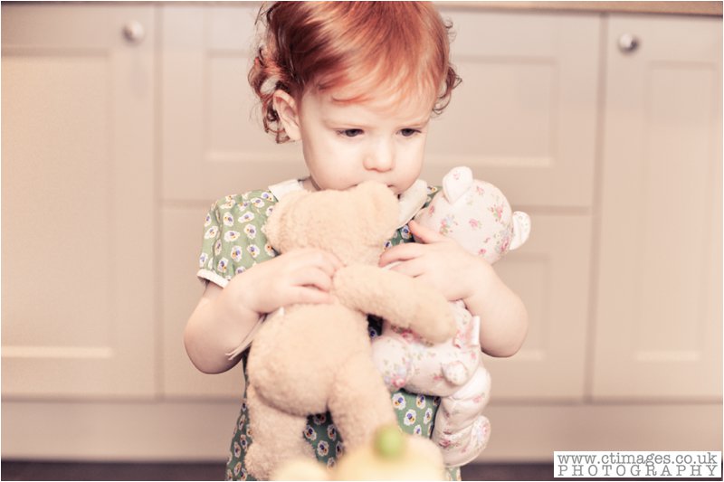 girl cuddling teddies, little girl photograph,