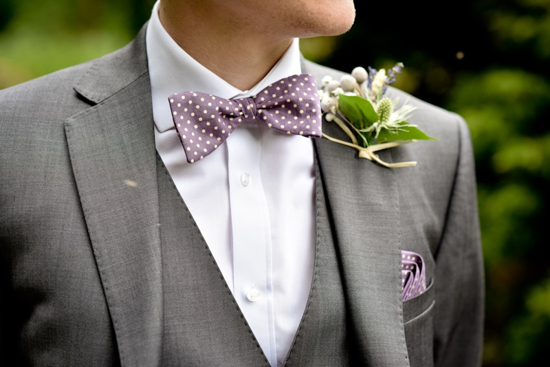 groom posing for photos at haigh hall wedding